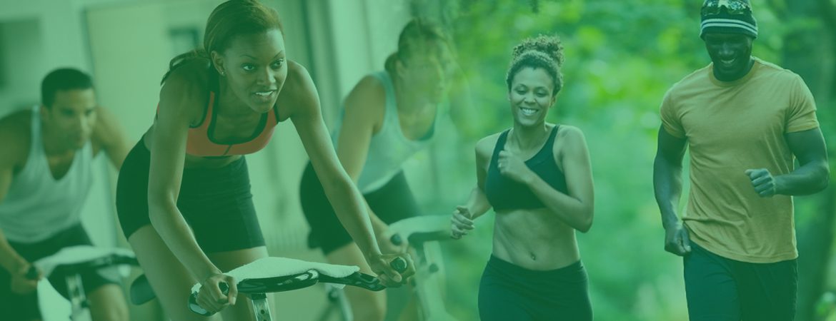 A group of women in gym clothes are smiling.