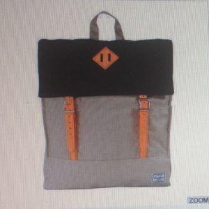 A backpack with orange straps and an orange logo.