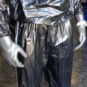 A person wearing silver clothing and gloves.