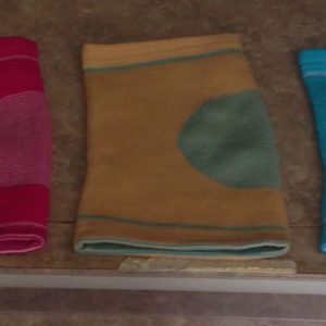 A close up of three different colored towels