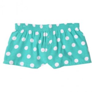 A pair of shorts with white polka dots on it.