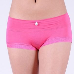 A woman wearing pink underwear with a pearl on the front of her bottom.