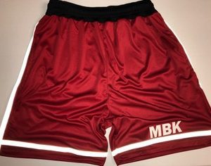 A pair of red basketball shorts with white stripes.