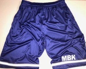 A pair of blue basketball shorts with mbk on the side.