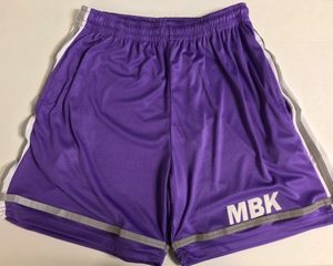 A pair of purple shorts with the letters mbk on it.