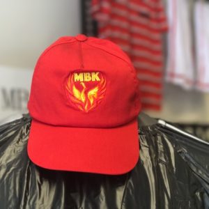 A red hat with the mbk logo on it.