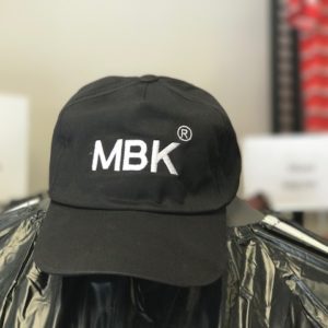 A black hat with mbk logo on it.