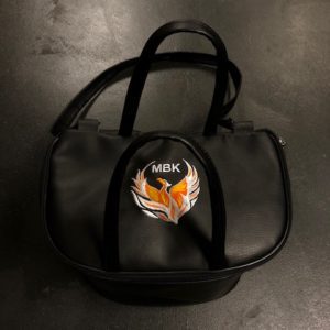 A black bag with an orange and white fox on it.